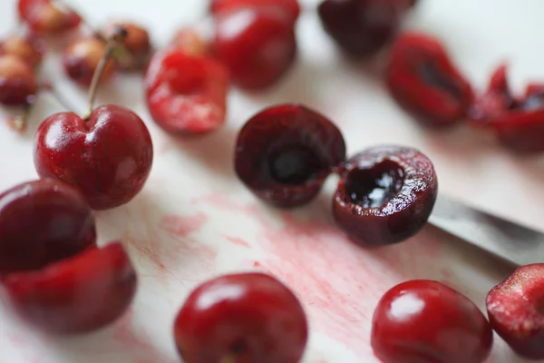 Pitted and whole red cherries  — Stok fotoğraf